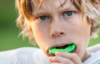 Boy putting in his mouth guard license confirmed
