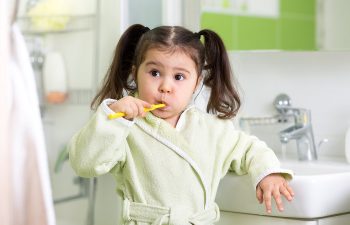 bigstock Child little girl brushing tee 114751514