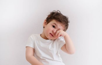 Little boy itchy his eyes with tear